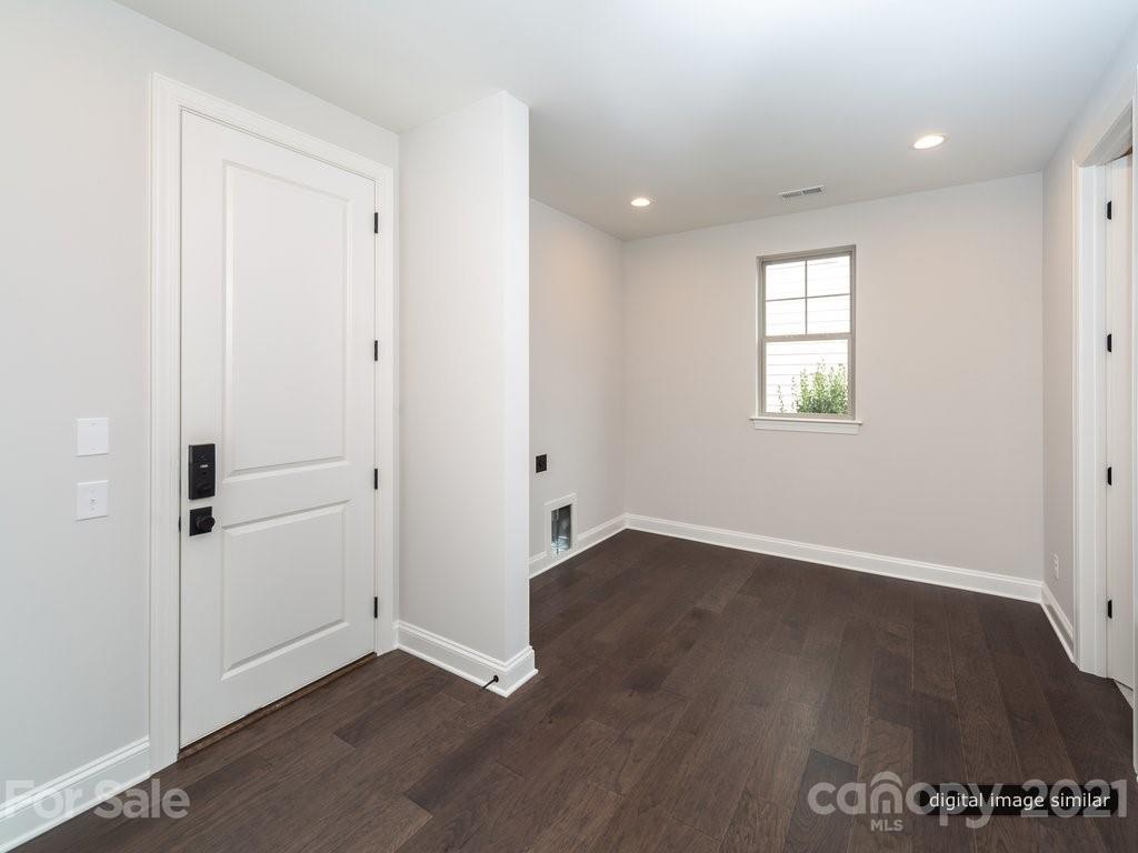 12031 Huntson Reserve Road Huntersville, NC 28078 - Photo 22 of 23 an empty room with wooden floor and windows