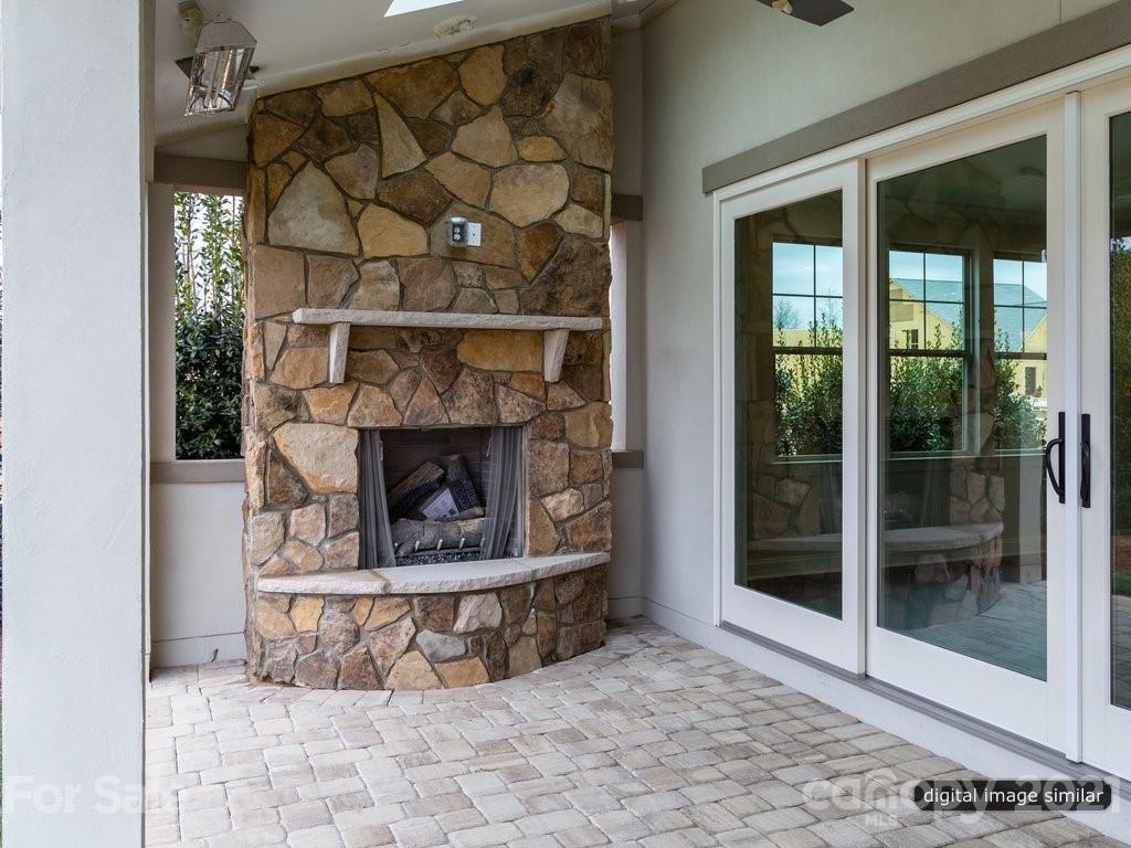 12031 Huntson Reserve Road Huntersville, NC 28078 - Photo 23 of 23 a living room with a fireplace and a floor to ceiling window