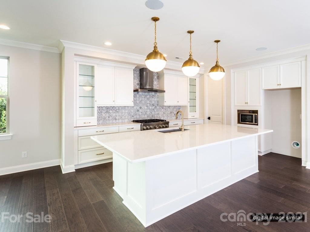 12031 Huntson Reserve Road Huntersville, NC 28078 - Photo 5 of 23 a large kitchen with kitchen island stainless steel appliances sink and wooden floor