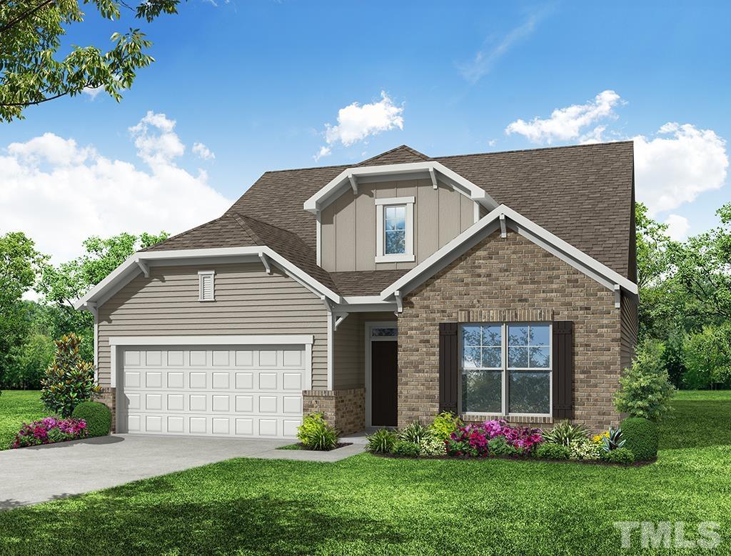 291 Ford Meadows Drive Garner, NC 27529 - Photo 1 of 13 a front view of a house with a garden and plants