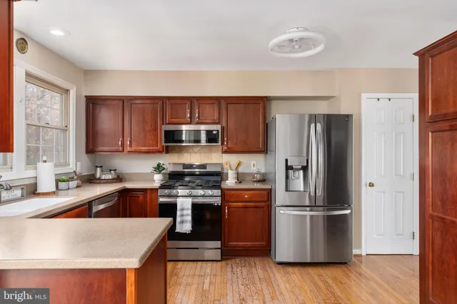 a kitchen with a sink stove top oven and cabinets