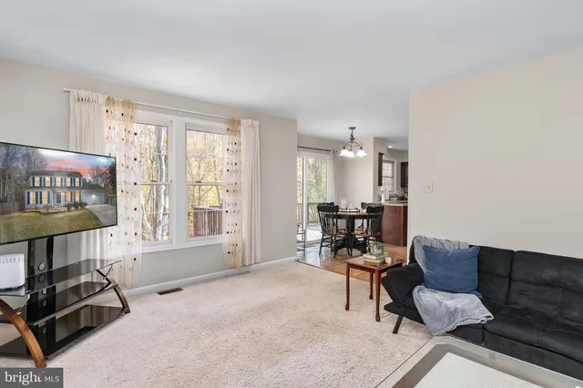 a bedroom with a bed a ceiling fan and a large window