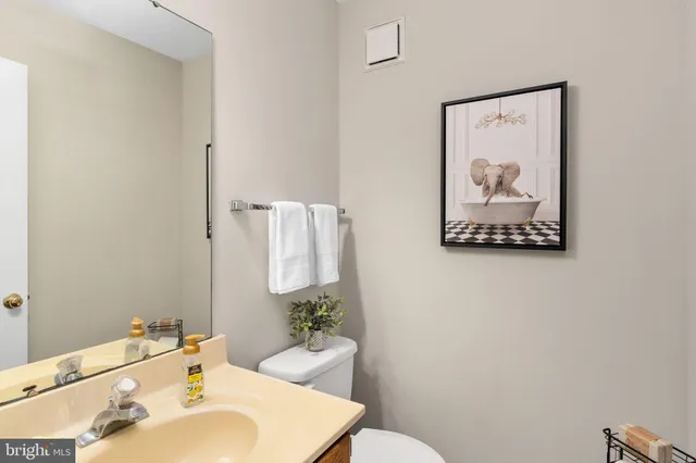 a spacious bedroom with a bed and a chandelier