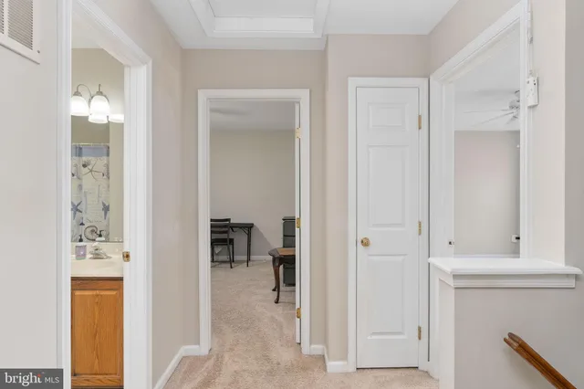 a bathroom with a granite countertop sink a toilet and a mirror