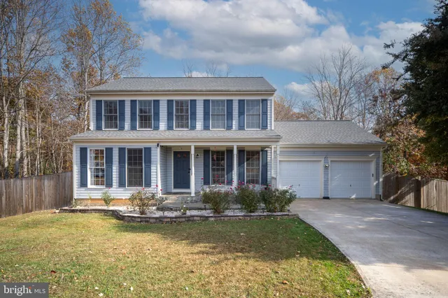 a front view of a house with swimming pool and lake view