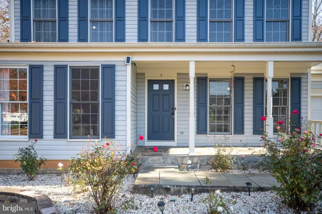 a view of a hallway with wooden floor and entryway