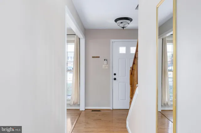 a view of entryway with wooden floor and stairs
