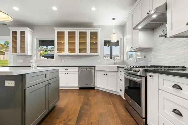 a kitchen with stainless steel appliances granite countertop a stove and a sink