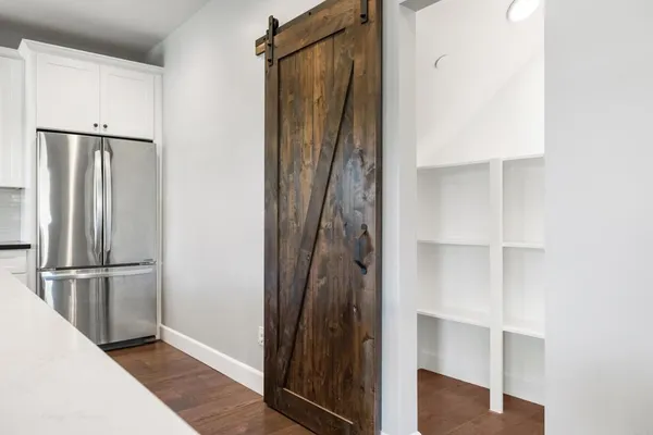 a view of walk in closet with empty racks