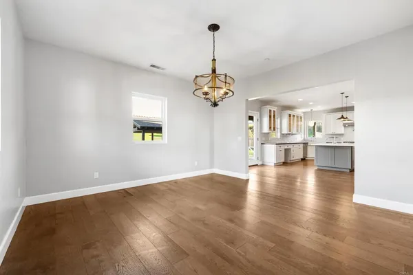 a view of a kitchen with a dishwasher cabinets and a wooden floor