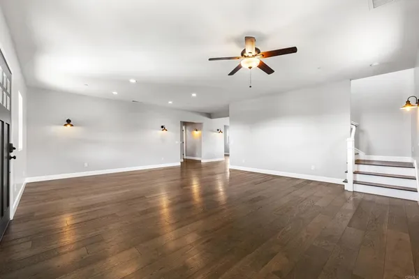 a view of a room with wooden floor and windows