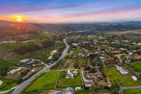 an aerial view of residential houses with outdoor space and river