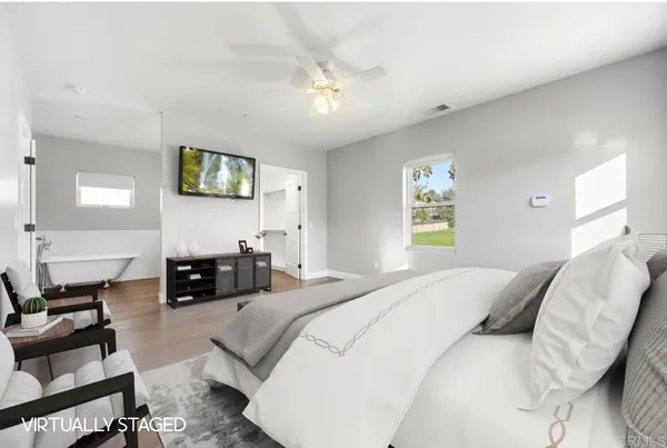 a bedroom with a bed couch and a window