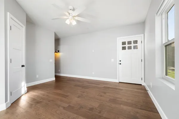 wooden floor in an empty room with a window