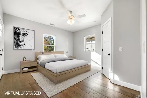 a bedroom with a large bed and a chandelier