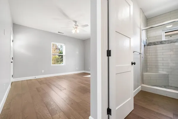 wooden floor in an empty room with a window