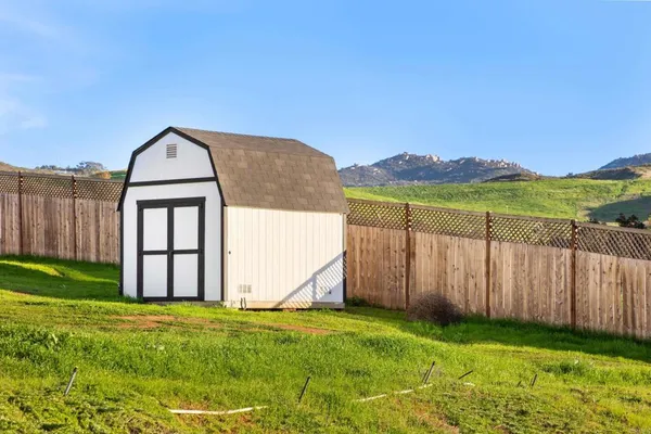 a view of a backyard with a garden and tub
