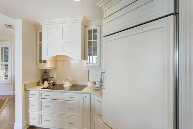 a living room with furniture and a large window with garden view