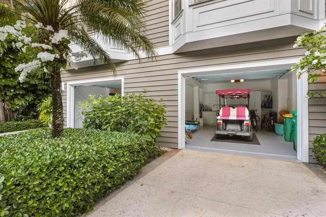 a room with lots of wooden furniture wooden floor and large windows