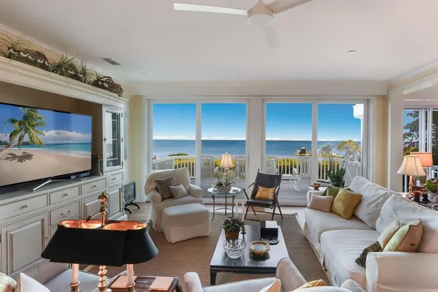 a view of a balcony with wooden floor and fence