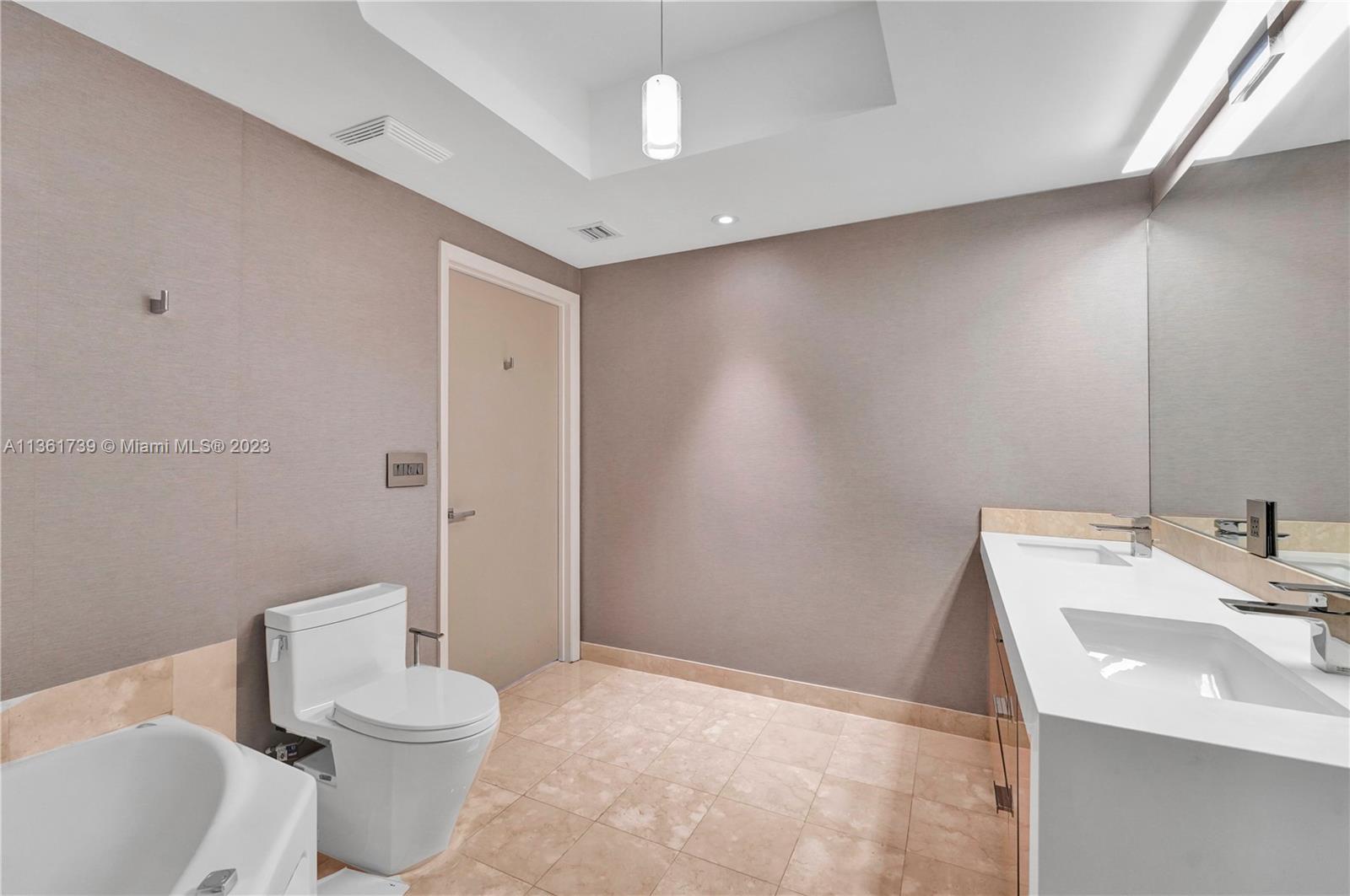 10 Venetian Way, Unit 603 Miami Beach, FL 33139 - Photo 15 of 30 a bathroom with a sink a toilet and shower