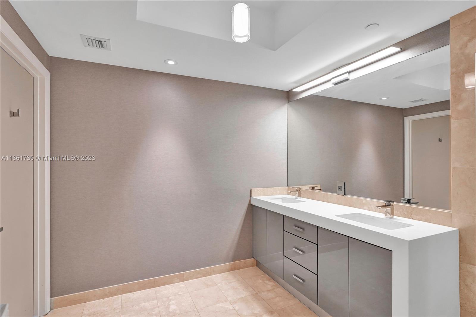 10 Venetian Way, Unit 603 Miami Beach, FL 33139 - Photo 16 of 30 a bathroom with a sink and a mirror