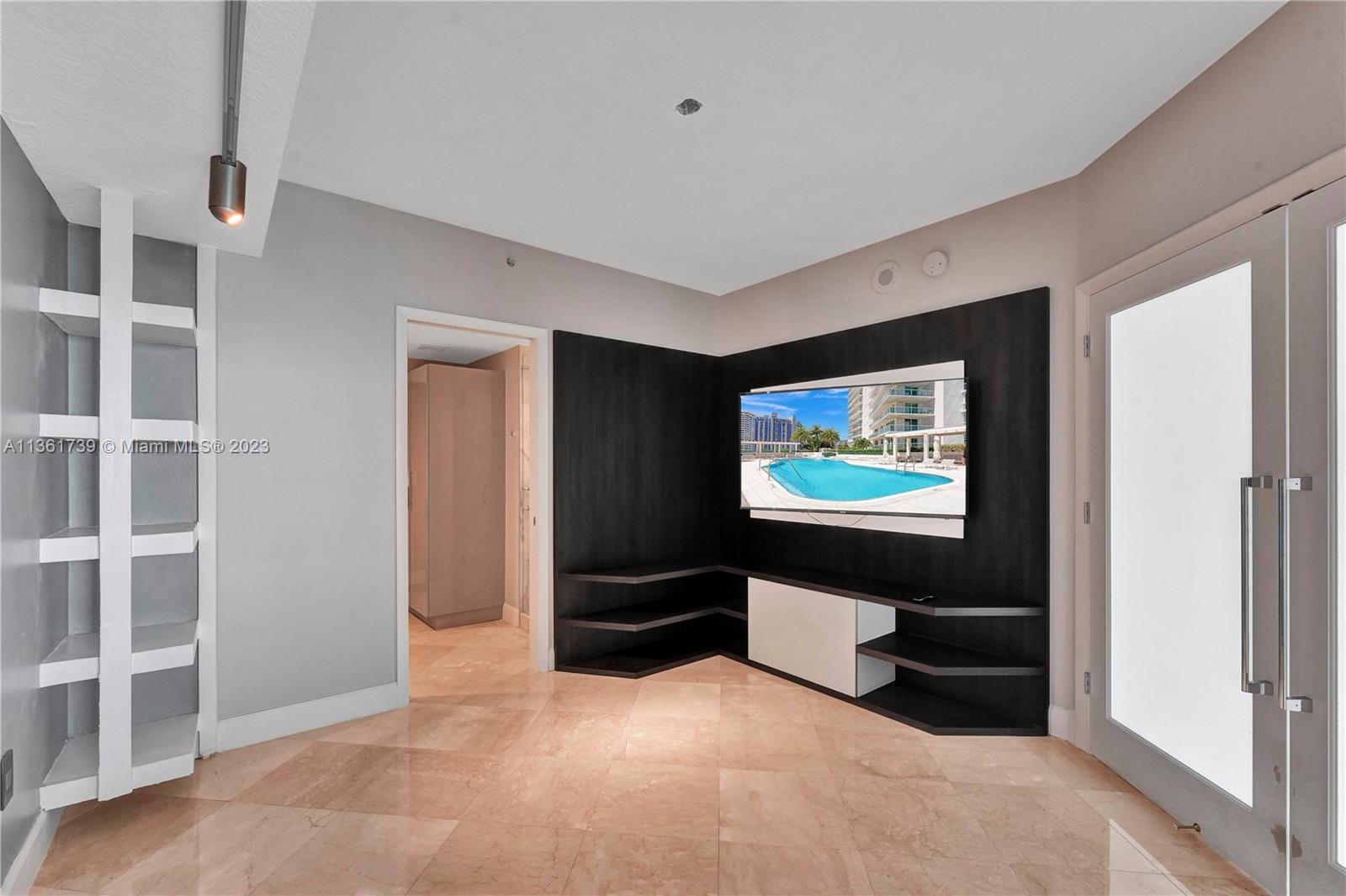 10 Venetian Way, Unit 603 Miami Beach, FL 33139 - Photo 17 of 30 a living room with furniture and a flat screen tv