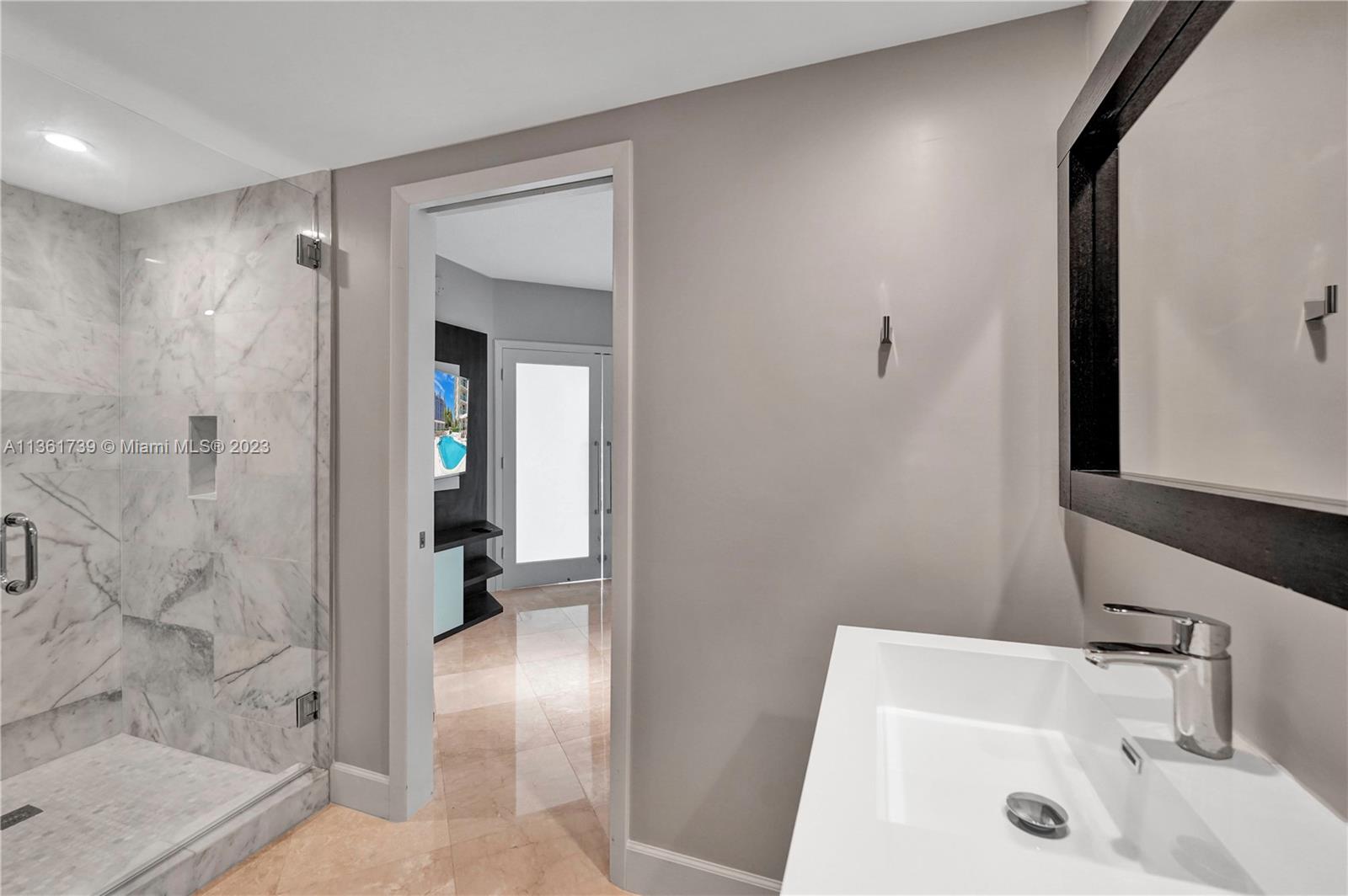 10 Venetian Way, Unit 603 Miami Beach, FL 33139 - Photo 20 of 30 a bathroom with a sink and a shower