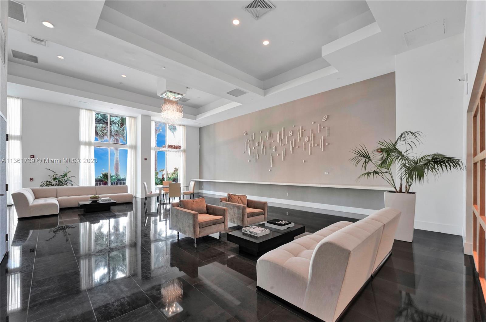 10 Venetian Way, Unit 603 Miami Beach, FL 33139 - Photo 22 of 30 a living room with furniture and a potted plant