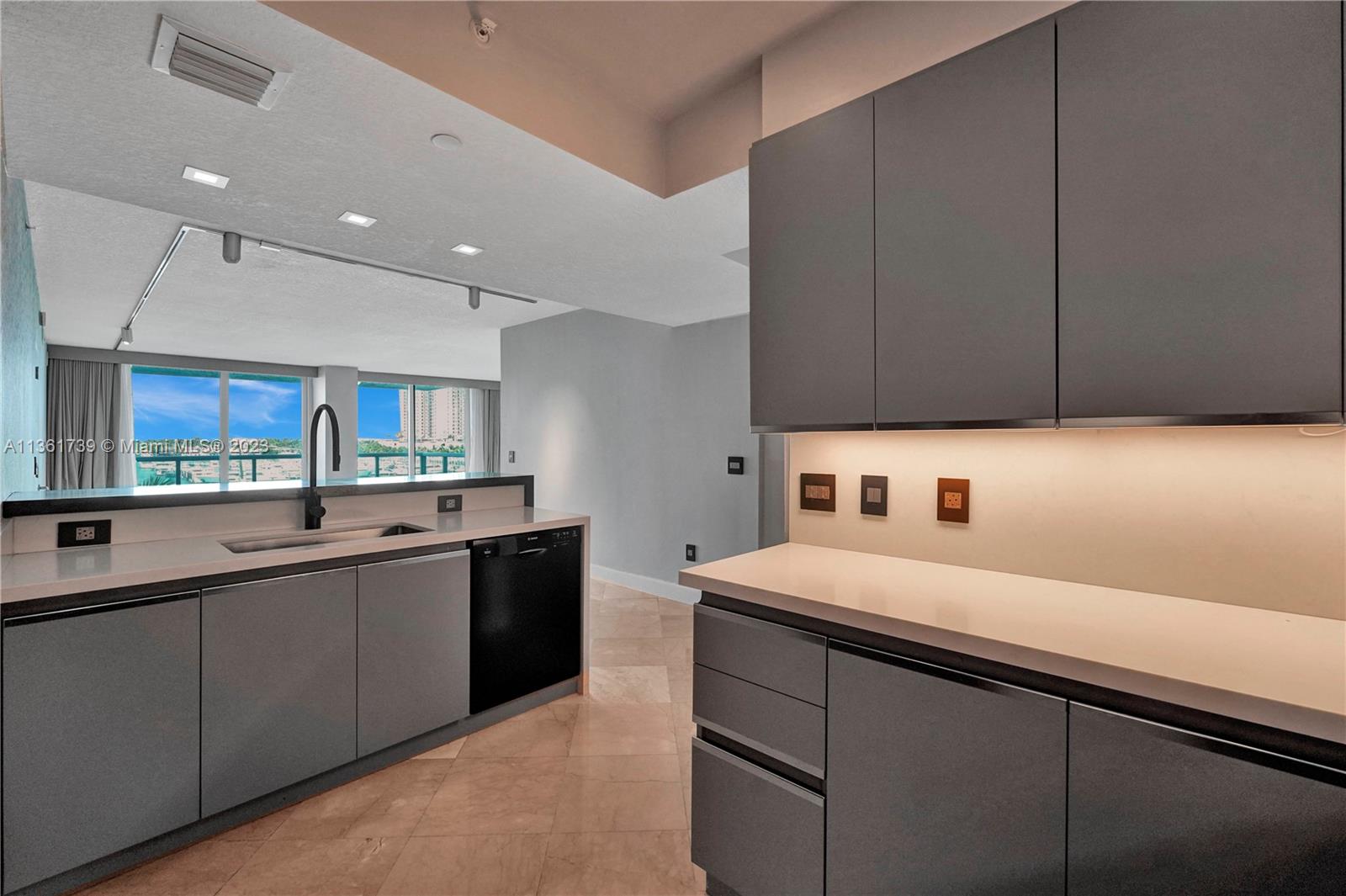 10 Venetian Way, Unit 603 Miami Beach, FL 33139 - Photo 7 of 30 a kitchen with a sink and cabinets