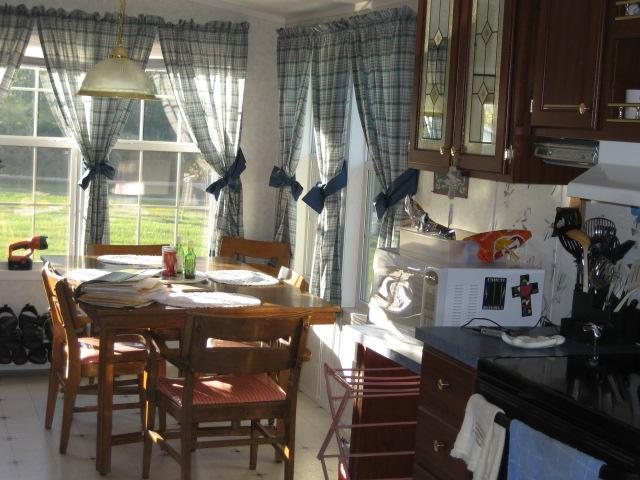 8865 Roanoke Road Elliston, VA 24087 - Photo 7 of 11 a view of a dining room with furniture and chandelier