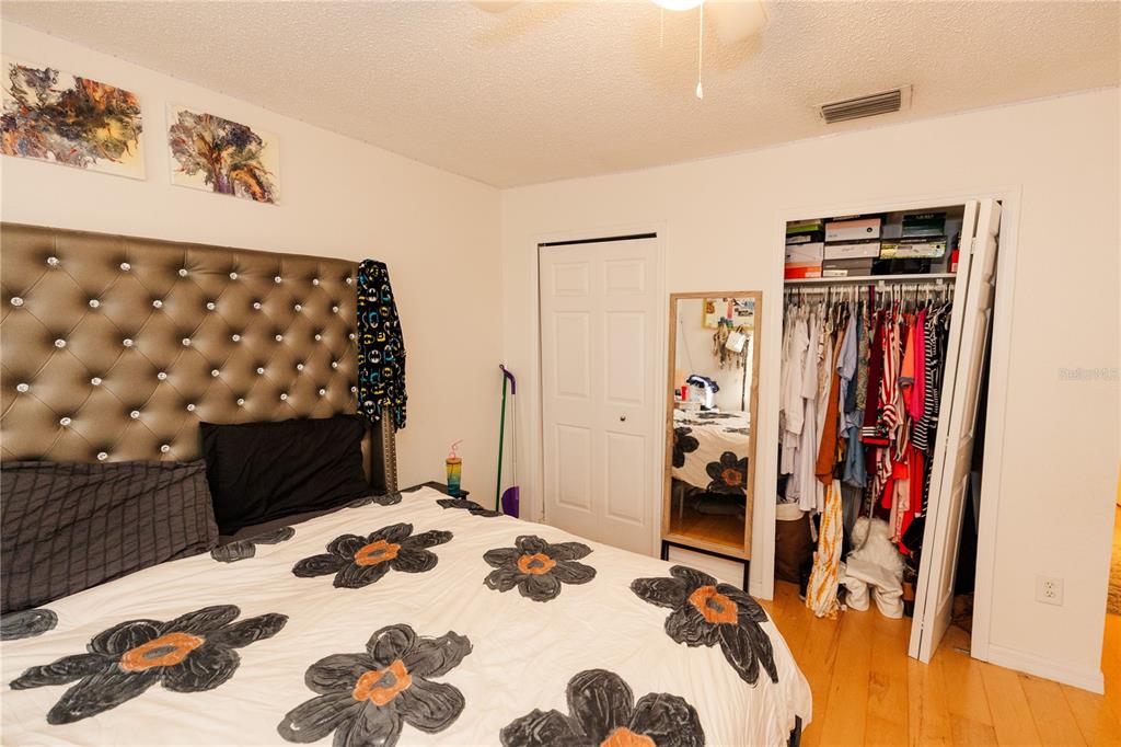 10819 Brickside Court Riverview, FL 33579 - Photo 13 of 22 a bedroom with a bed and a dresser
