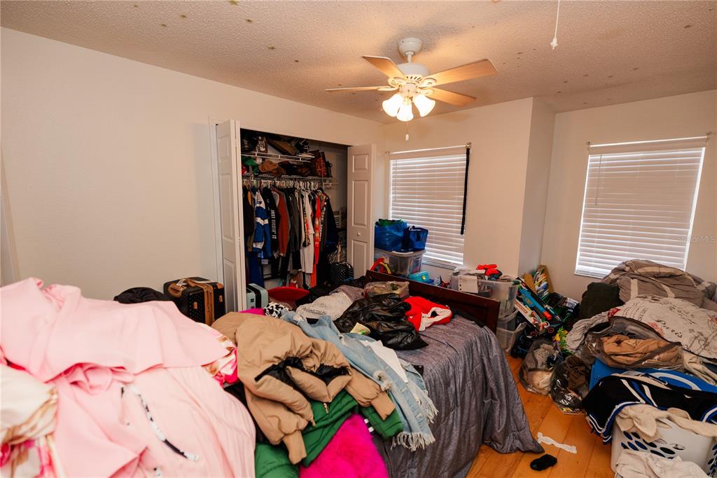 10819 Brickside Court Riverview, FL 33579 - Photo 17 of 22 a bedroom with a bed and a chandelier