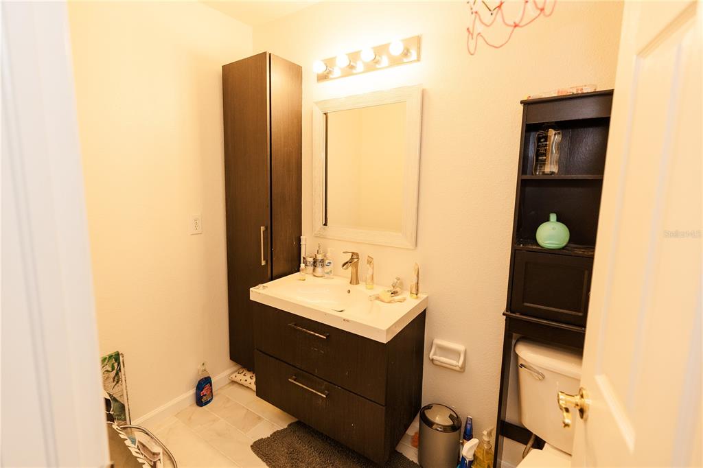 10819 Brickside Court Riverview, FL 33579 - Photo 18 of 22 a bathroom with a sink vanity and mirror