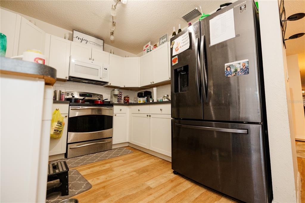 10819 Brickside Court Riverview, FL 33579 - Photo 9 of 22 a kitchen with stainless steel appliances a refrigerator sink and cabinets