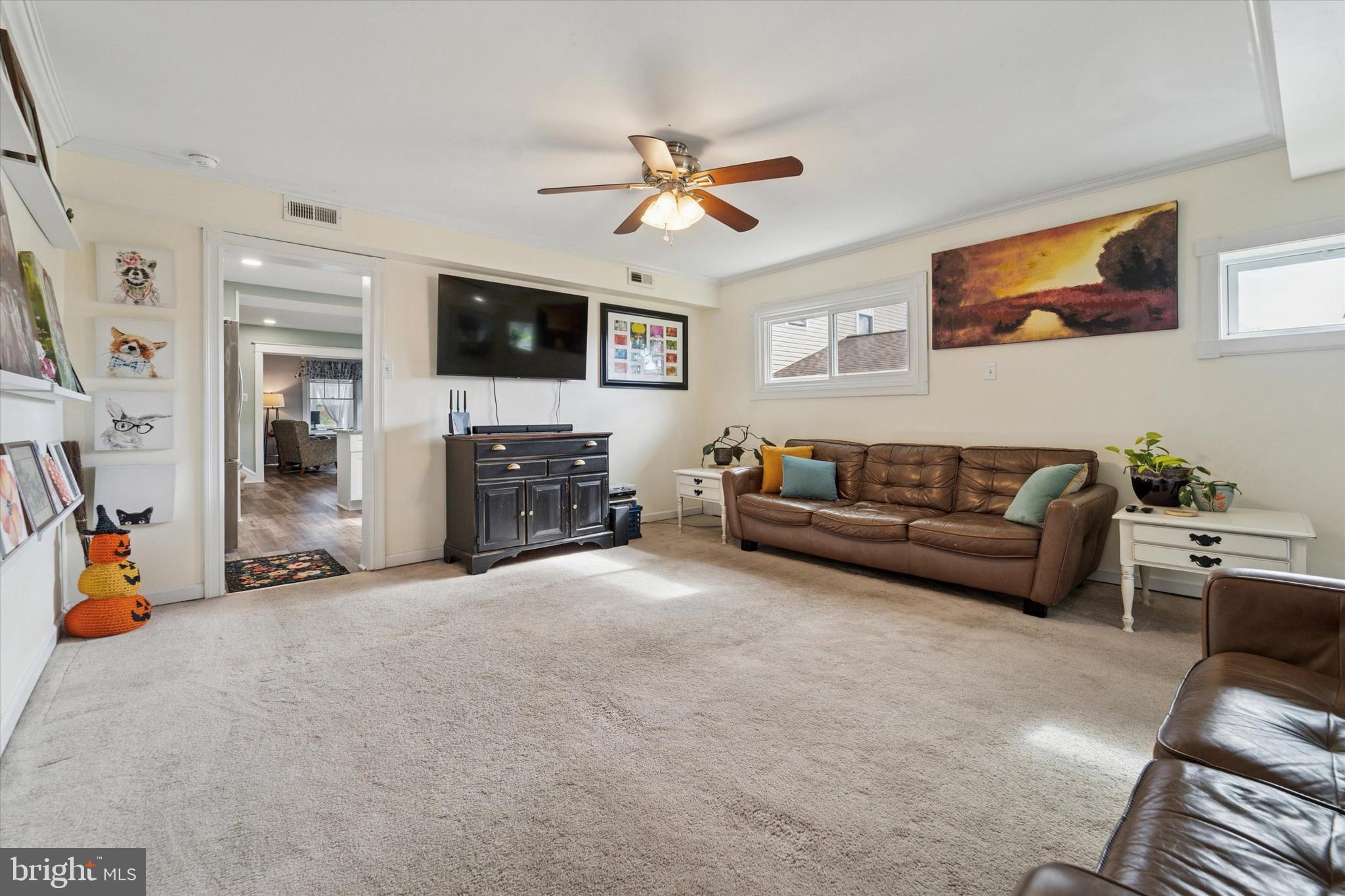 339 Sutton Avenue Folsom, PA 19033 - Photo 11 of 26 a living room with furniture a flat screen tv and a fireplace
