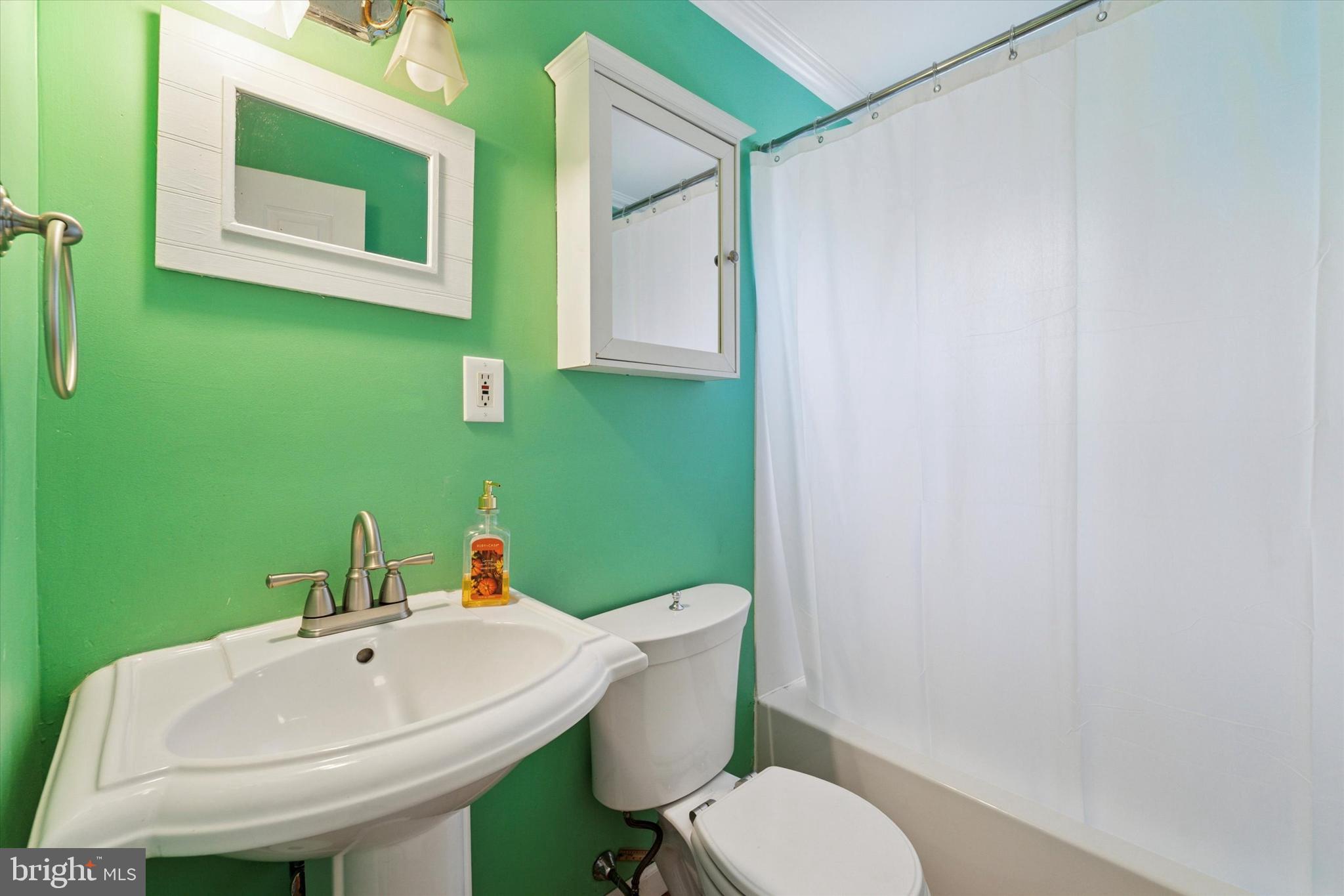 339 Sutton Avenue Folsom, PA 19033 - Photo 12 of 26 a white toilet sitting next to a bathroom sink