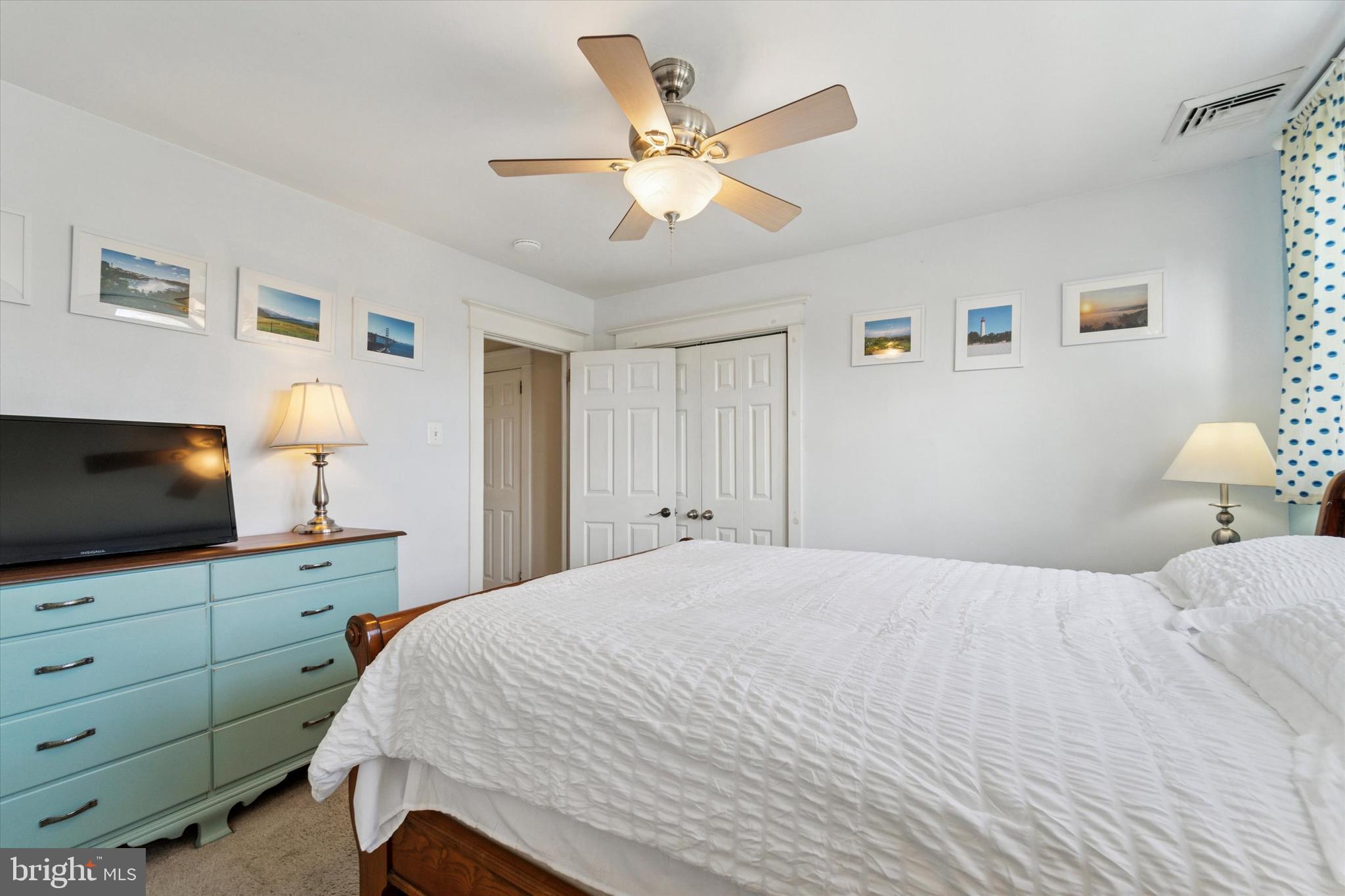 339 Sutton Avenue Folsom, PA 19033 - Photo 14 of 26 a bedroom with a large bed and a flat tv screen on dresser