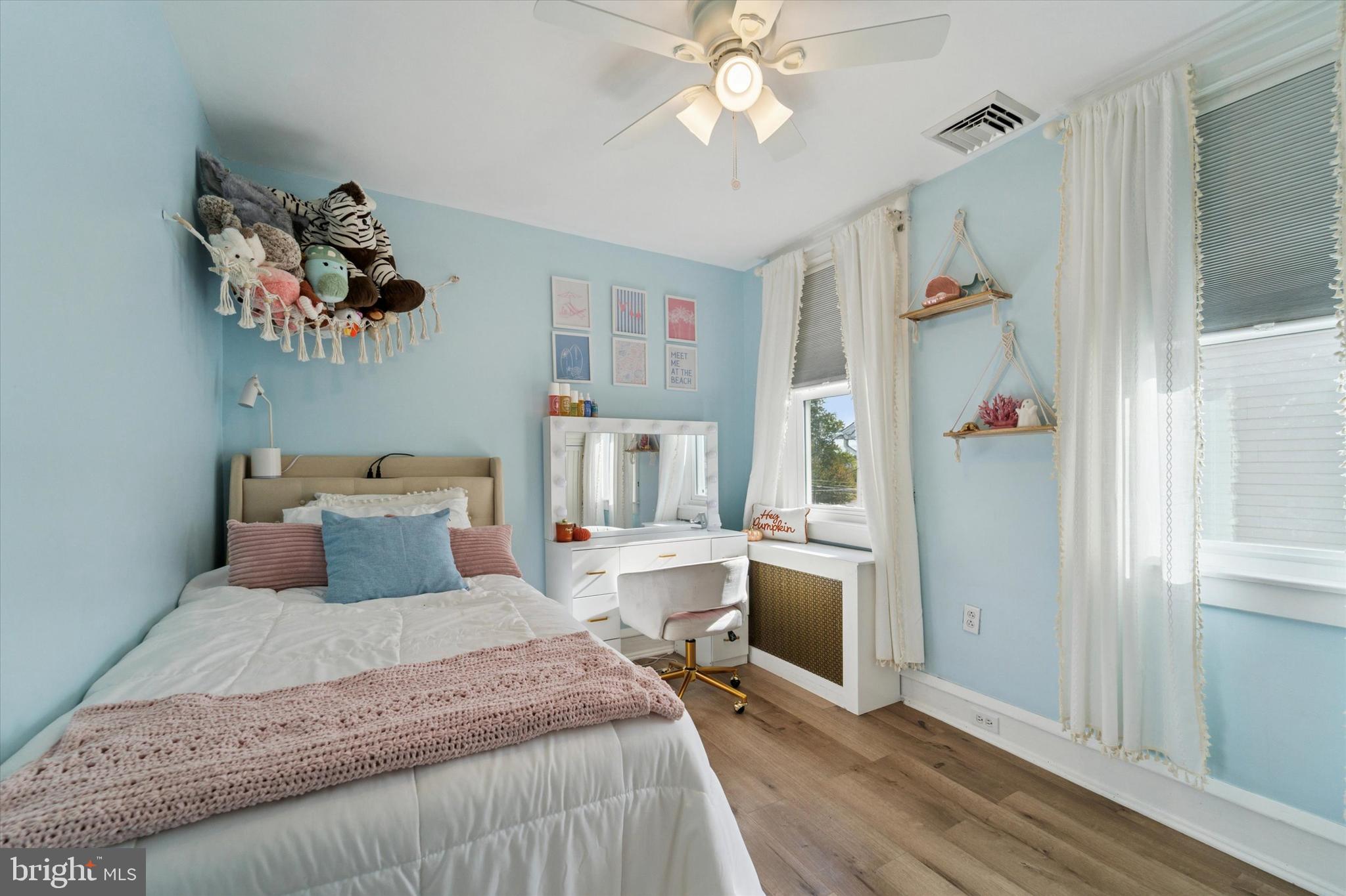 339 Sutton Avenue Folsom, PA 19033 - Photo 16 of 26 a bedroom with a large bed a chandelier and dresser