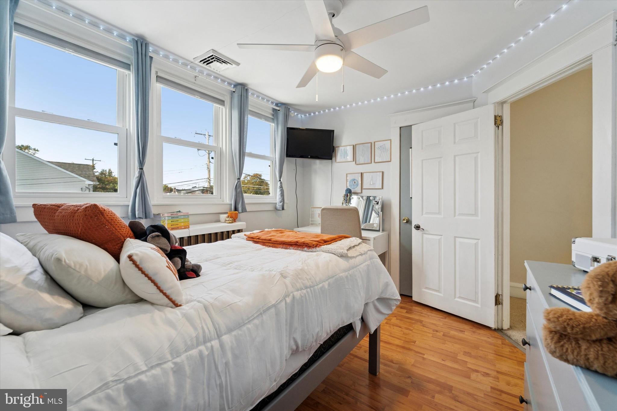 339 Sutton Avenue Folsom, PA 19033 - Photo 20 of 26 a bedroom with a bed flat screen tv and a couch