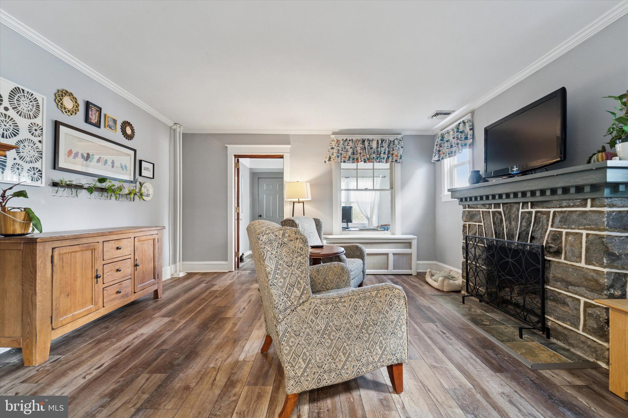 339 Sutton Avenue Folsom, PA 19033 - Photo 4 of 26 a living room with furniture a flat screen tv and a fireplace