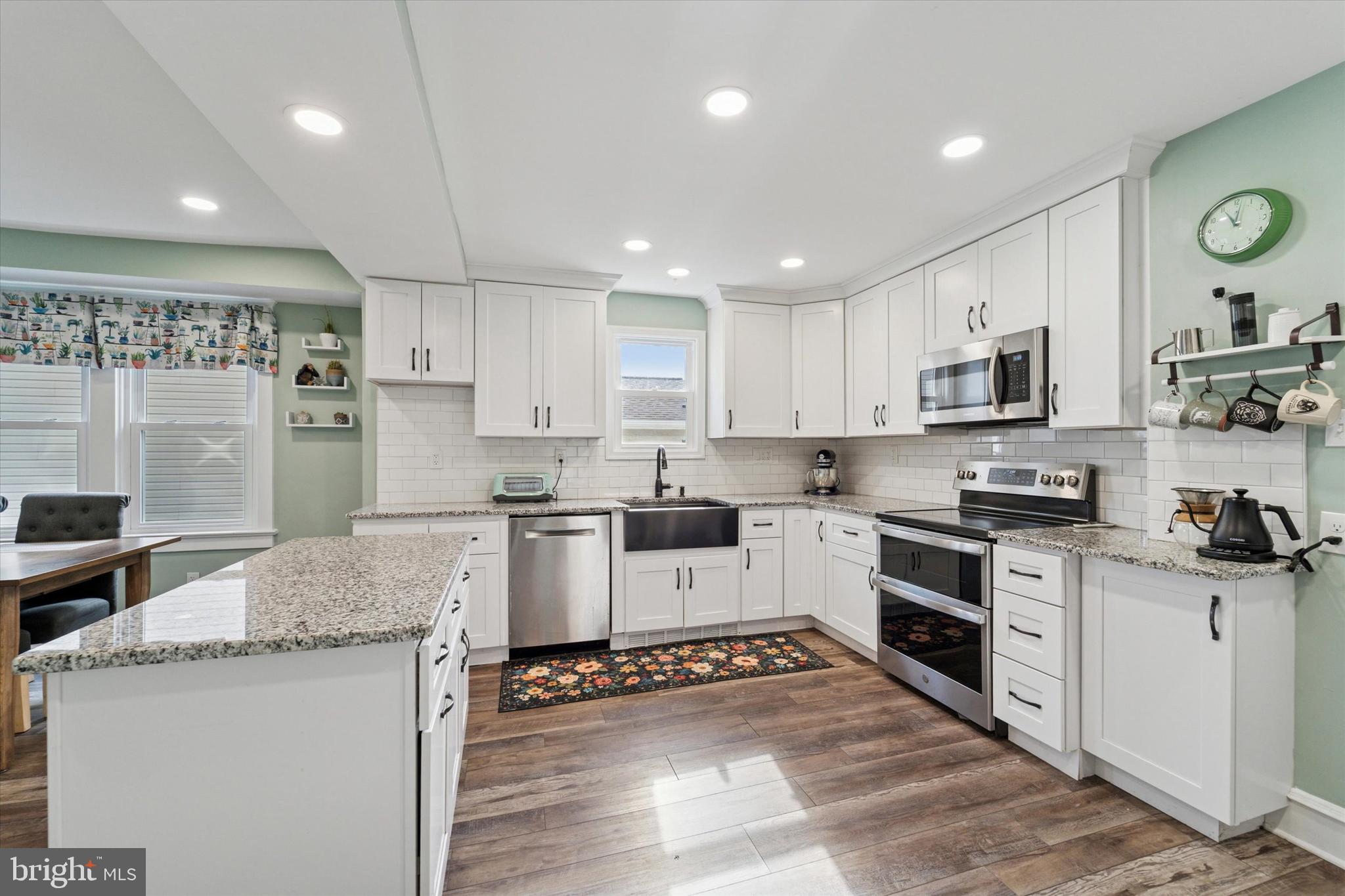 339 Sutton Avenue Folsom, PA 19033 - Photo 8 of 26 a kitchen with granite countertop kitchen island wooden cabinets and stainless steel appliances