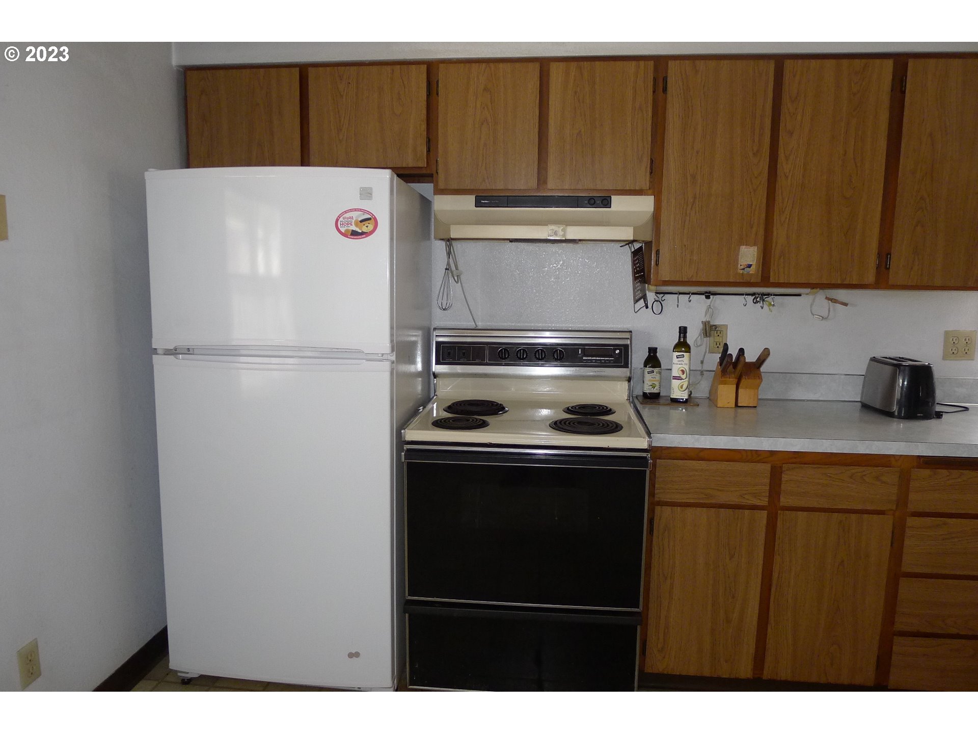 238 North 9th Street Reedsport, OR 97467 - Photo 14 of 38 a white refrigerator freezer sitting inside of a kitchen