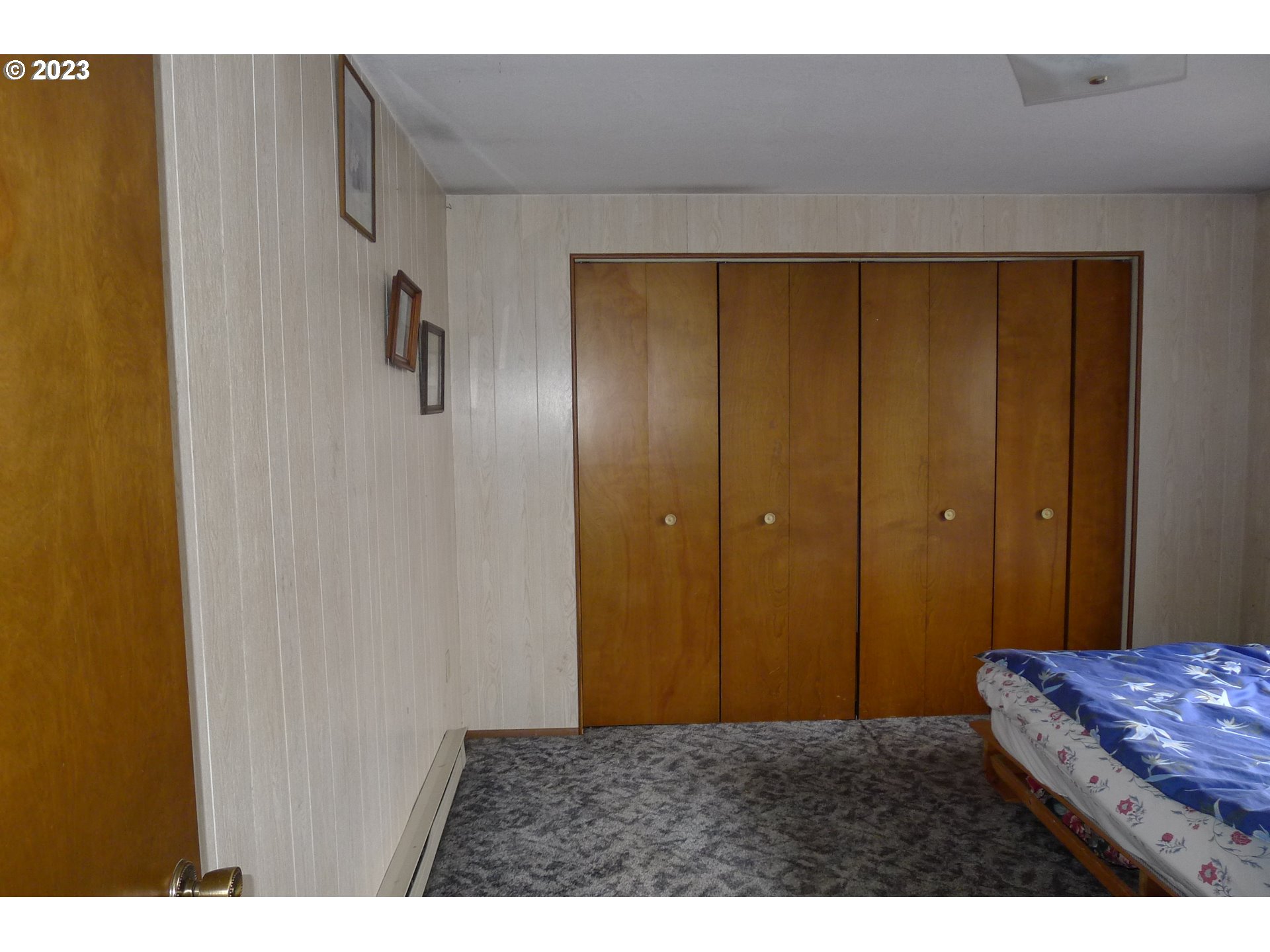 238 North 9th Street Reedsport, OR 97467 - Photo 24 of 38 a bedroom with a bed and wooden floor