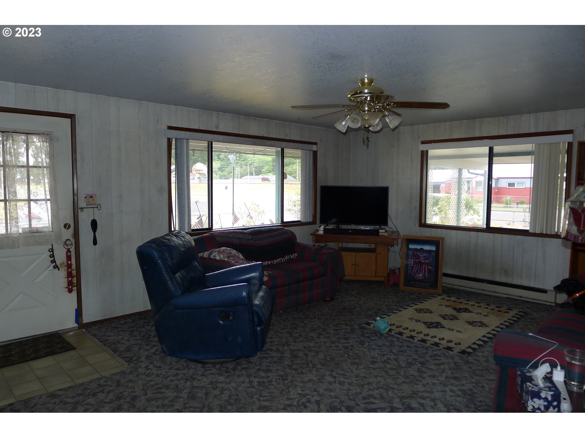 238 North 9th Street Reedsport, OR 97467 - Photo 10 of 38 a living room with furniture and a flat screen tv