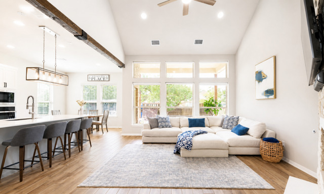 1928 Lakeside Ranch Road Georgetown, TX 78633 - Photo 5 of 37 A luminous living space features generous windows, wood floors, and vaulted ceilings.
