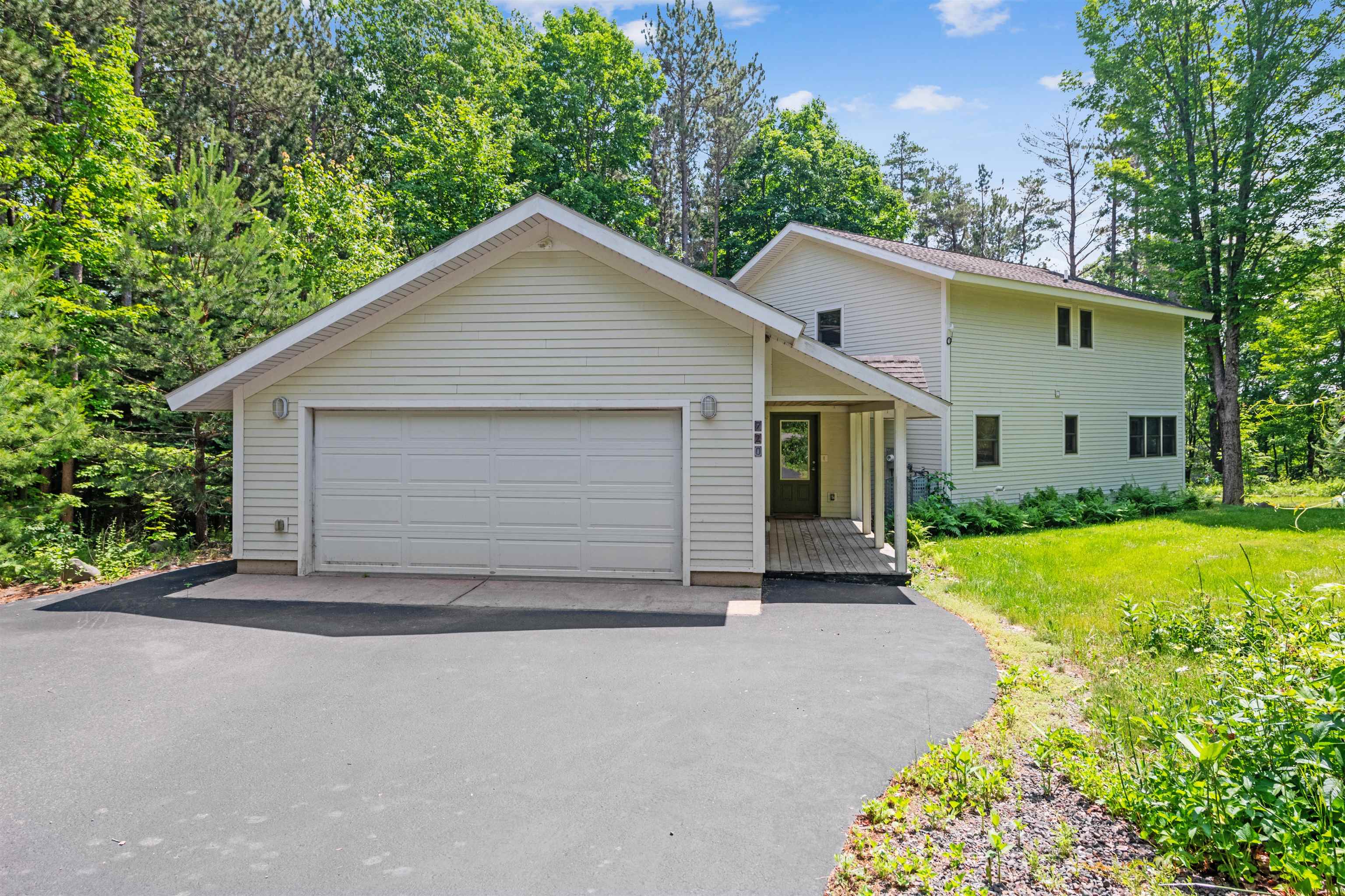 View of front of home with a front lawn and an attached garage