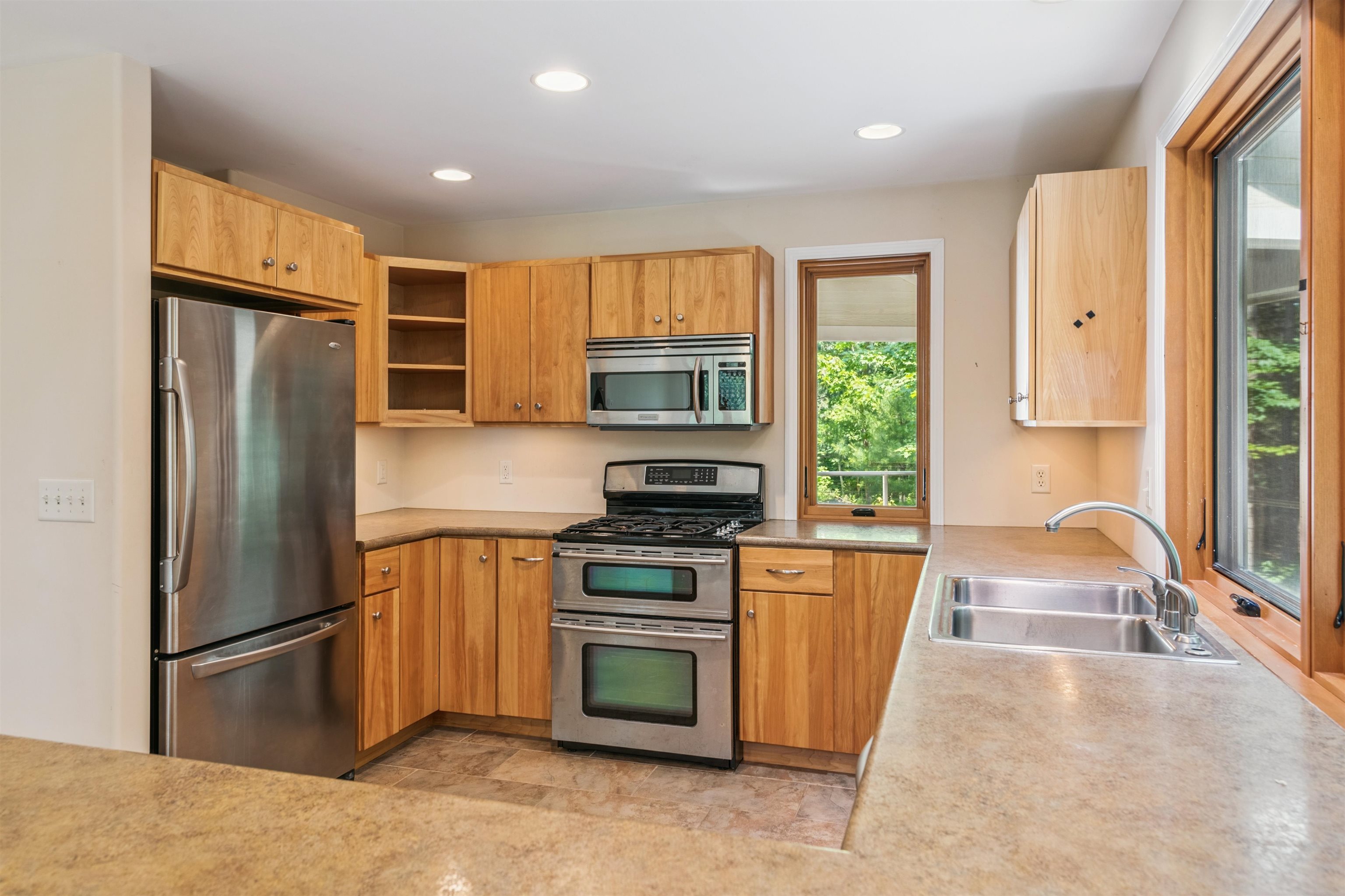 720 Rice Avenue Bayfield, WI 54814 - Photo 13 of 47 Kitchen featuring stainless steel appliances, recessed lighting, open shelves, and light countertops