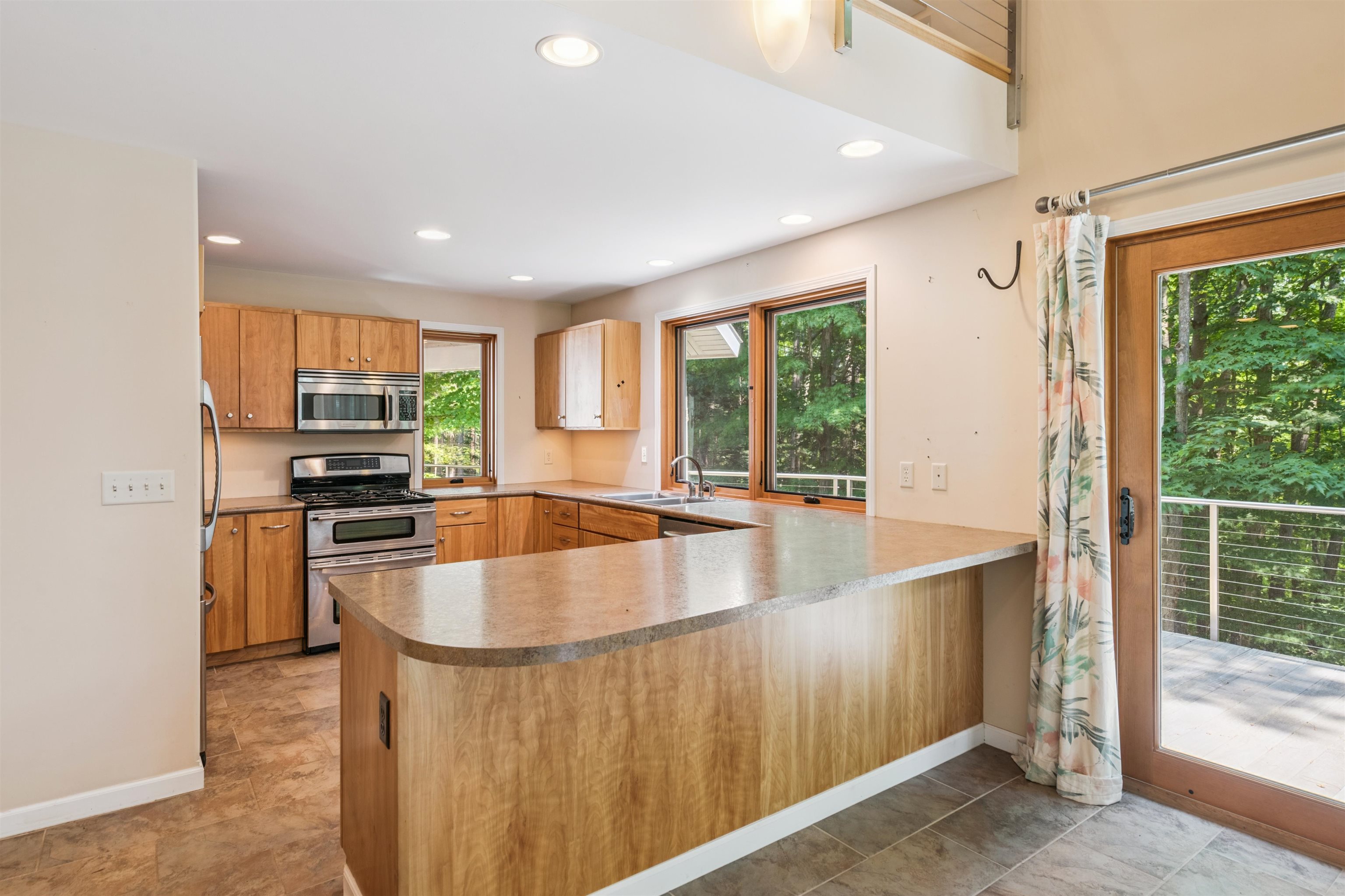 720 Rice Avenue Bayfield, WI 54814 - Photo 14 of 47 Kitchen featuring a peninsula, stainless steel appliances, recessed lighting, and light countertops