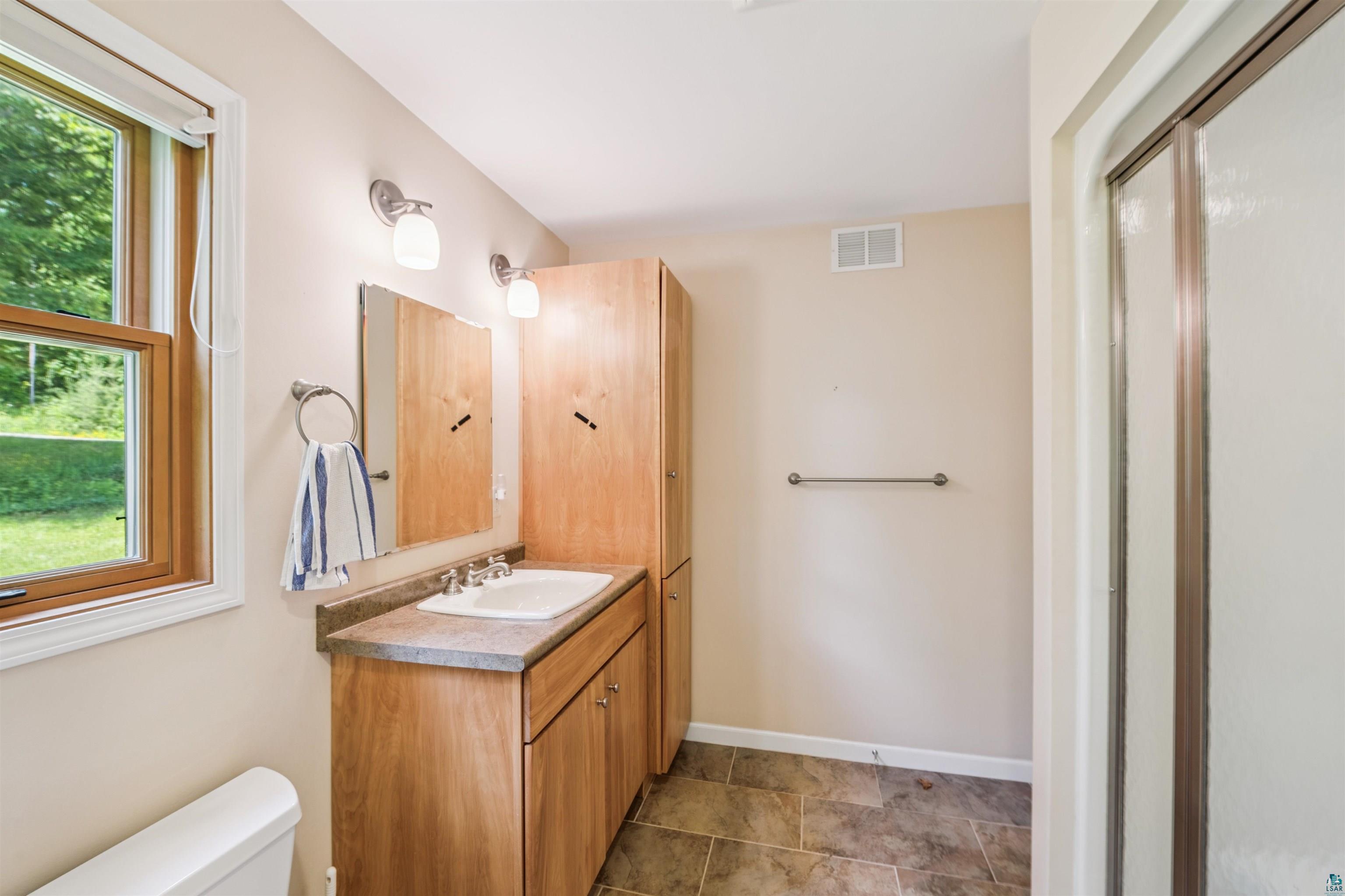 720 Rice Avenue Bayfield, WI 54814 - Photo 17 of 47 Bathroom with vanity and an enclosed shower